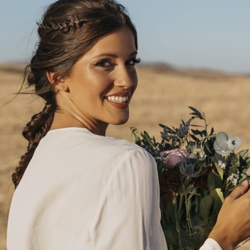 side-view-smiley-woman-holding-flowers